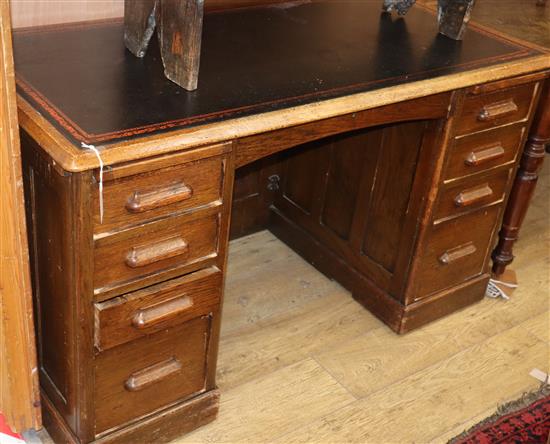 A 1920s oak pedestal desk W.135cm